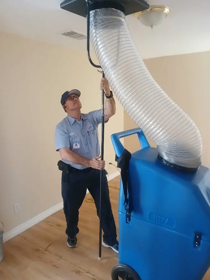 Furnace Tune-Up technician using HEPA equipment in Redlands